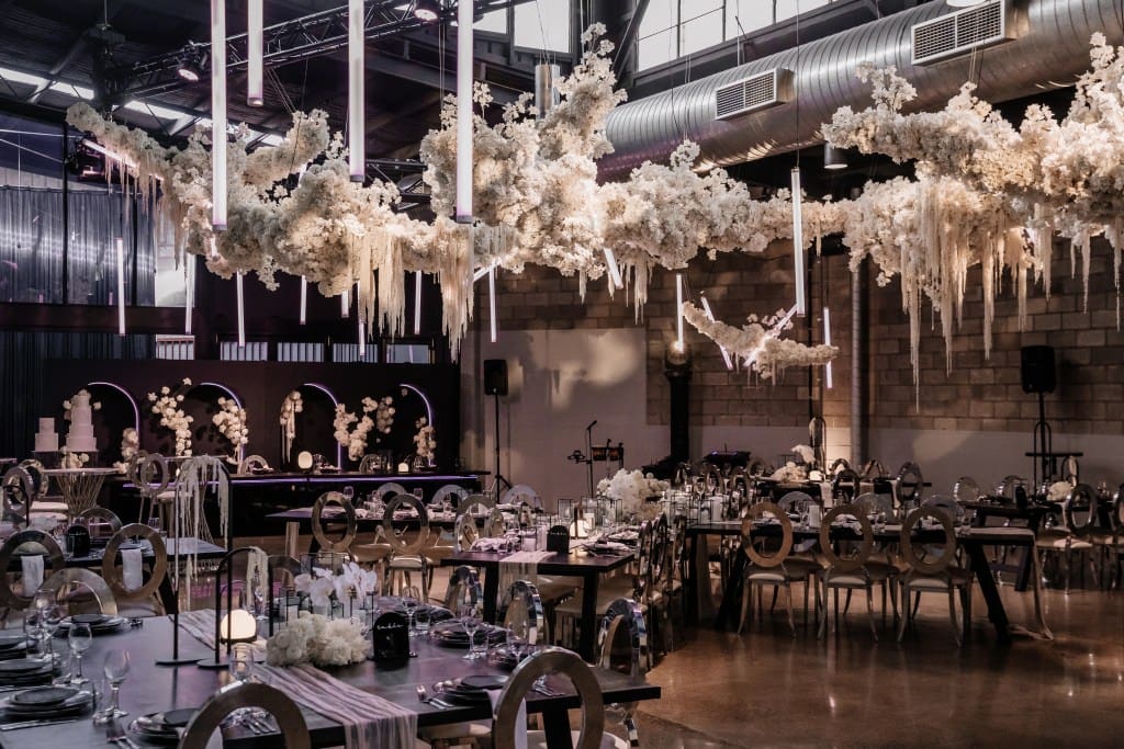 Suspended white floral installation above a Brisbane wedding reception.