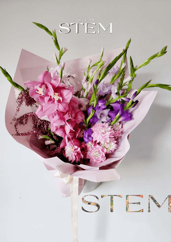 Pink orchid and dahlia floral arrangement by Stem Design.