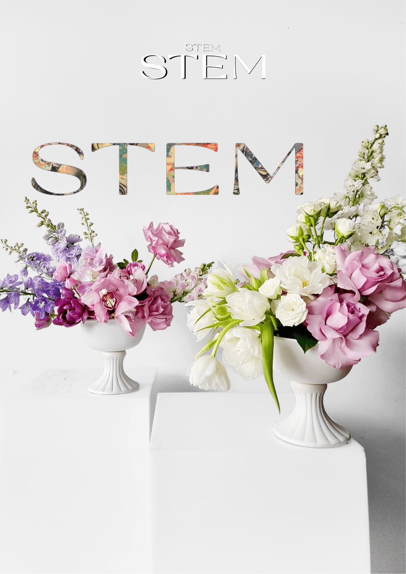 Two white pedestal vases filled with pink roses, purple delphiniums, and white tulips, showcasing modern floral design by Stem Design Brisbane.