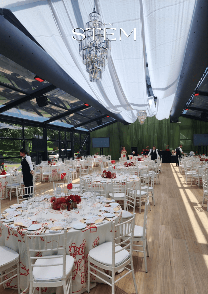 Event flowers Brisbane by Stem Design featuring red and burgundy roses, orchids, and anthuriums at Glo House, Roma Street Parklands by Glo Events.