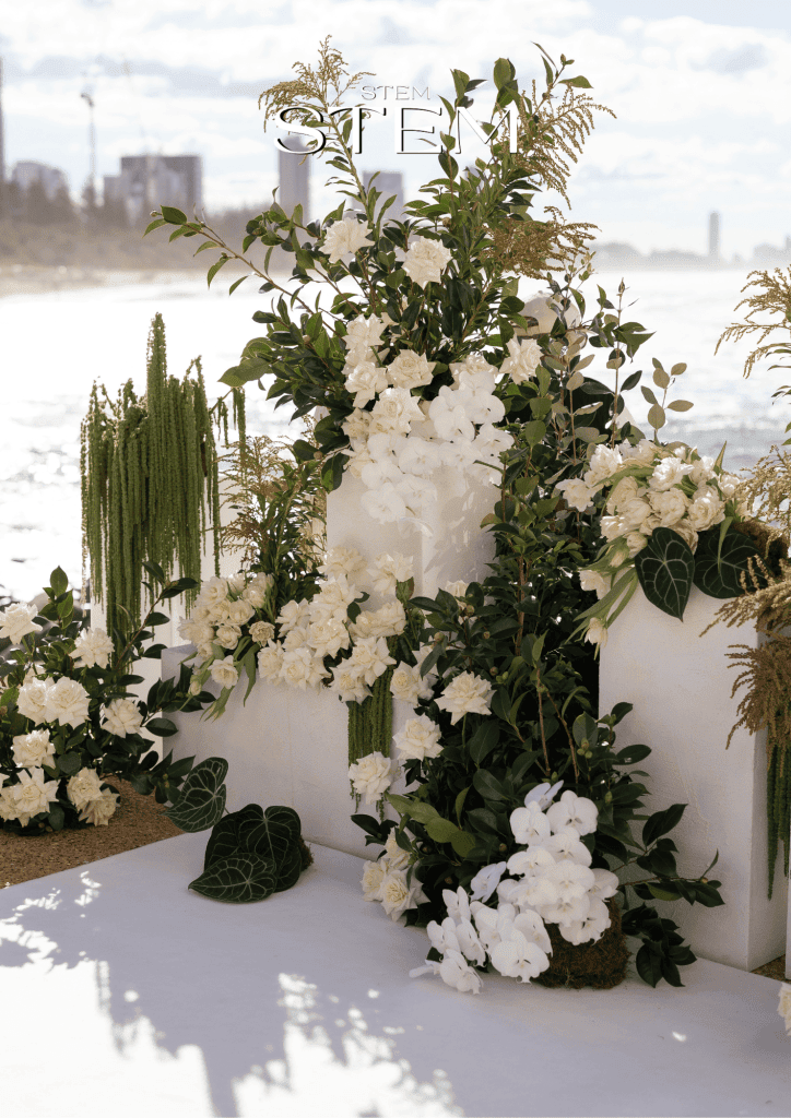 White wedding flowers with orchids, roses and greenery arranged at Rick Shores on the Gold Coast.