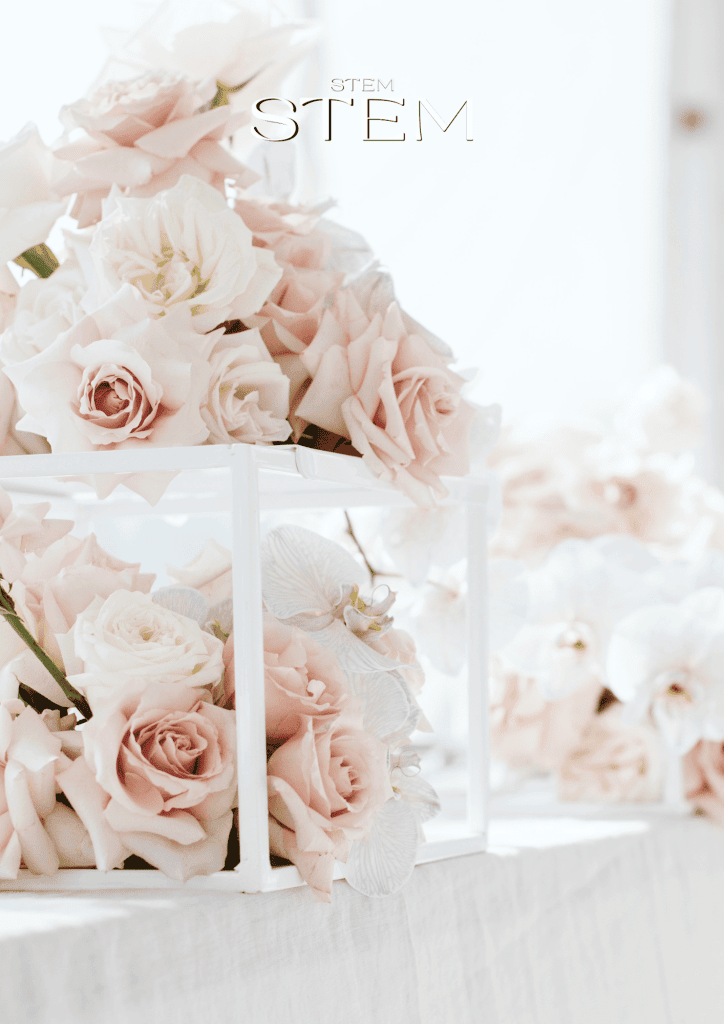 wedding floral designer styling soft blush and white wedding flowers for an elegant reception table