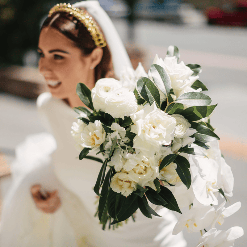 Bride holding white and green wedding bouquet