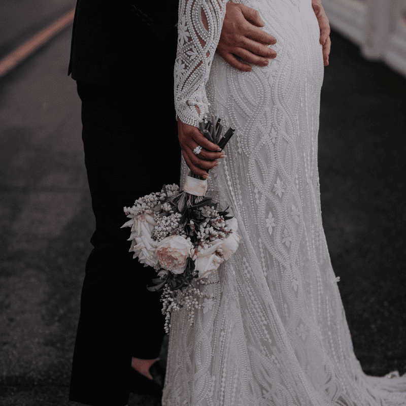 Bride holding a small white wedding bouquet