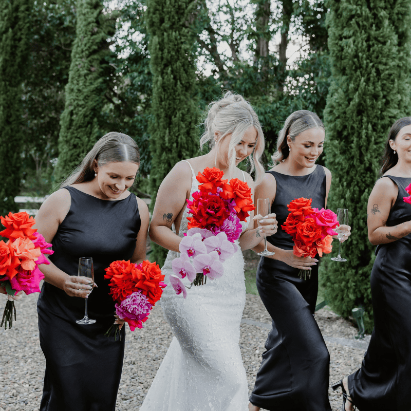 Bride with colourful red pink and orange wedding bouquet